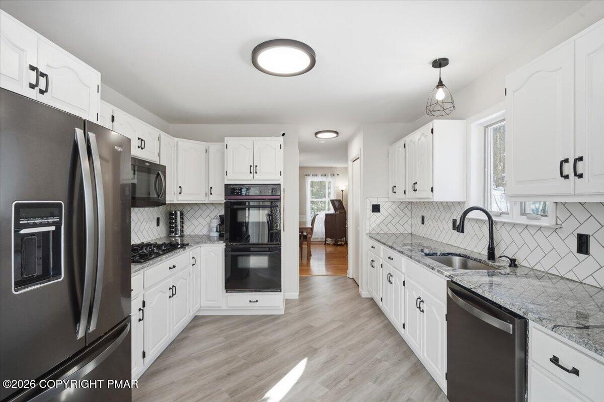 8824 Laird Road Stroudsburg, PA 18360 - Photo 11 of 53 a kitchen with stainless steel appliances granite countertop a refrigerator sink and cabinets