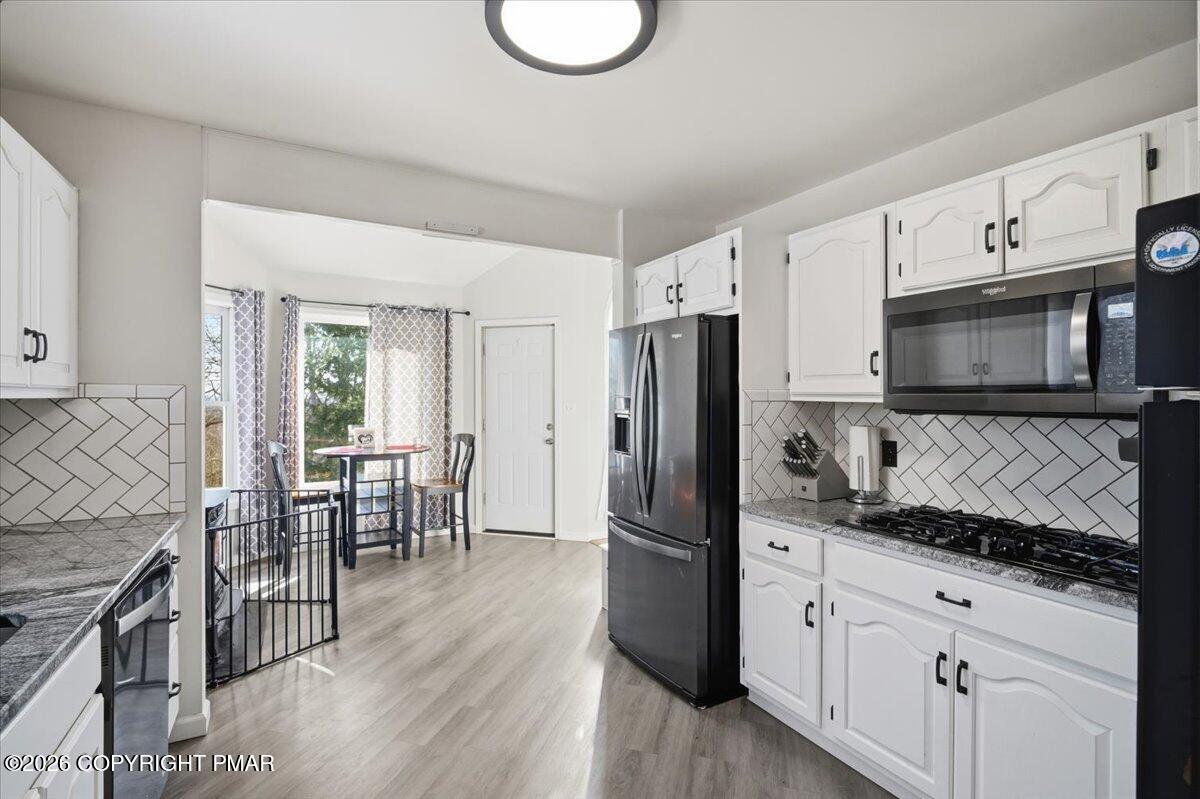 8824 Laird Road Stroudsburg, PA 18360 - Photo 12 of 53 a kitchen with wooden cabinets and stainless steel appliances