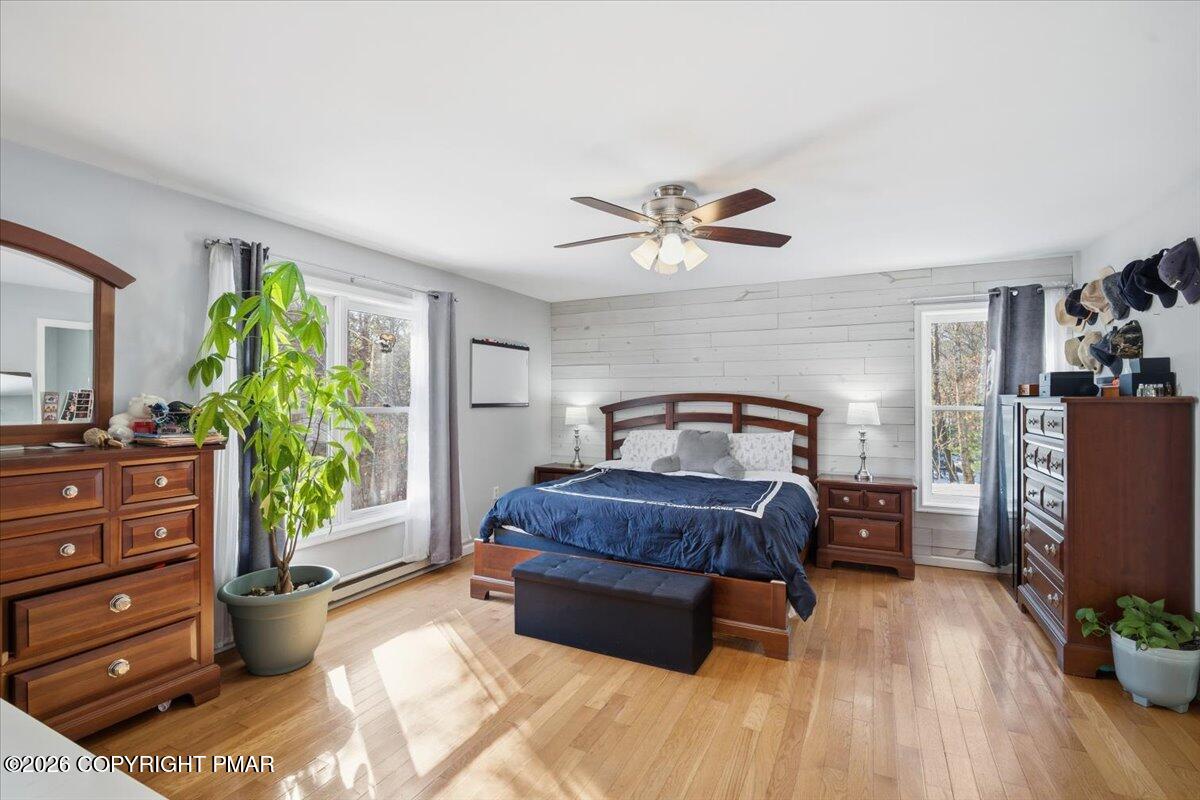 8824 Laird Road Stroudsburg, PA 18360 - Photo 16 of 53 a spacious bedroom with a bed and a chandelier