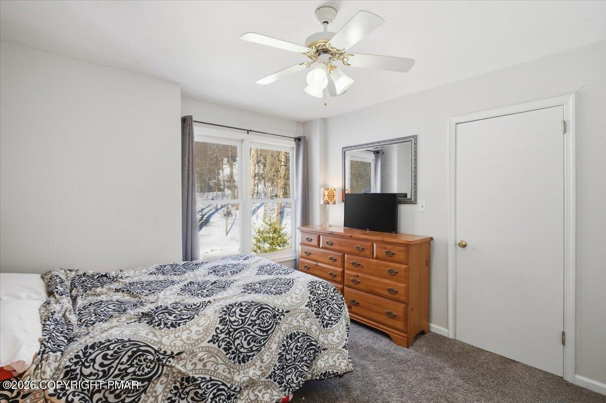 8824 Laird Road Stroudsburg, PA 18360 - Photo 17 of 53 a bedroom with a bed and a chandelier