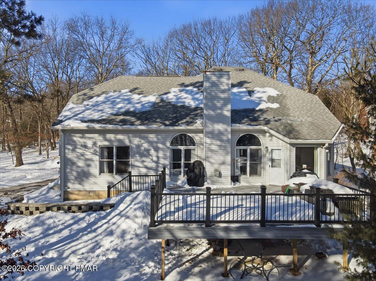 8824 Laird Road Stroudsburg, PA 18360 - Photo 23 of 53 a view of a brick house with large trees and wooden fence
