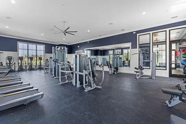 a view of a room with gym equipment and a large window