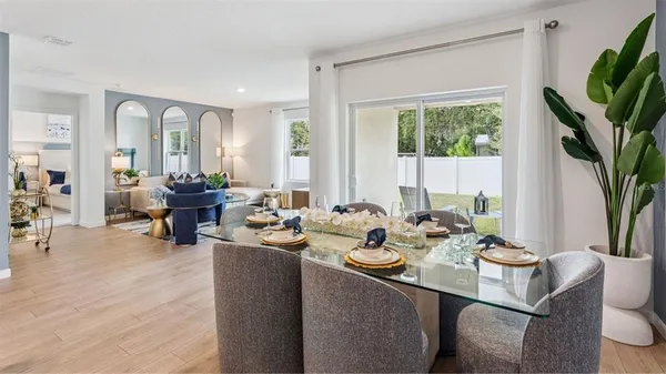 a view of a dining room with furniture and wooden floor