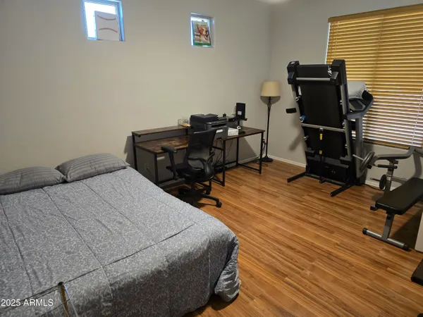 a bed sitting in a bedroom next to a window and furniture
