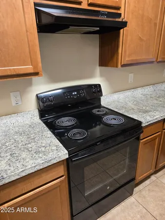 a kitchen with stainless steel appliances wooden cabinets a refrigerator and a sink