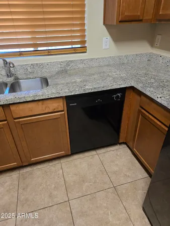 a kitchen with granite countertop a sink and a stove