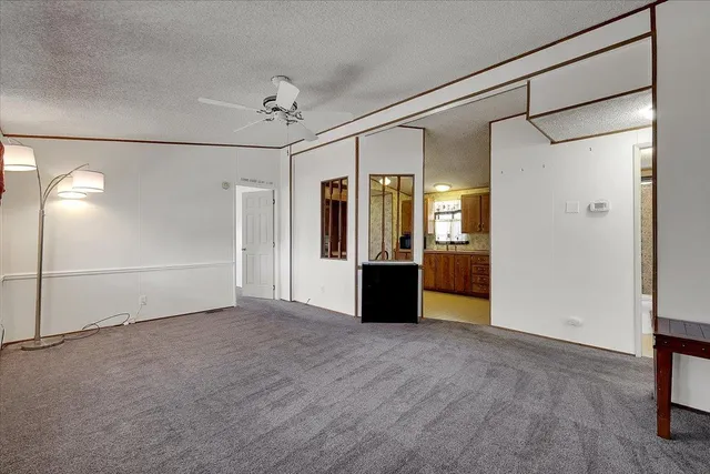 a view of an empty room with a kitchen