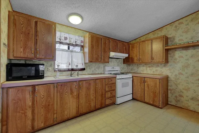a kitchen with wooden cabinets and a sink