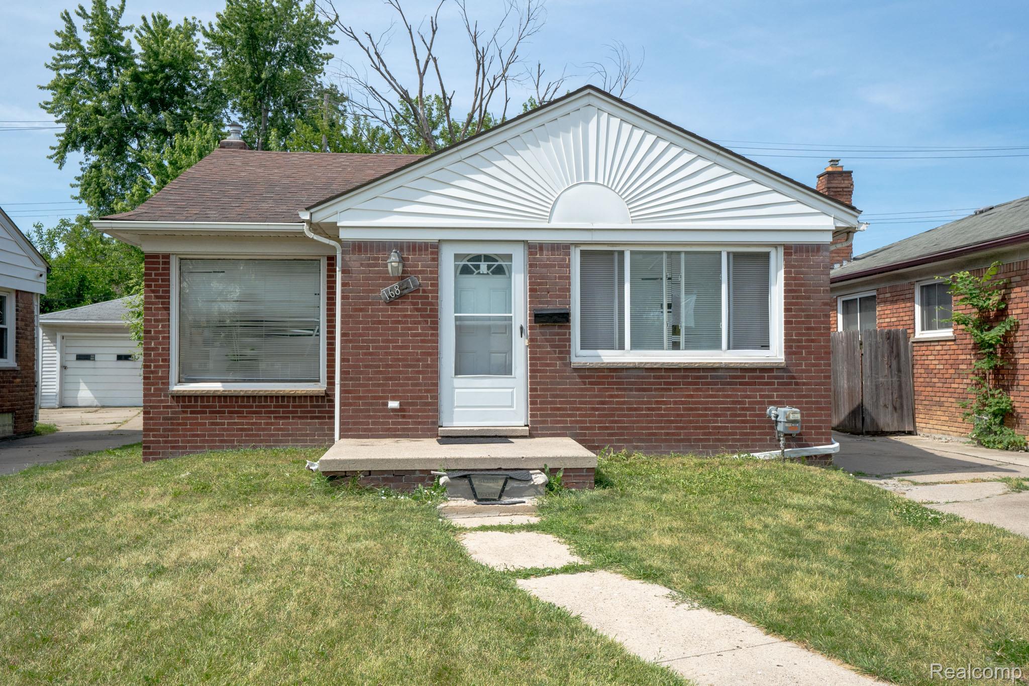 16821 East Eight Mile Road Eastpointe, MI 48021 - Photo 2 of 31 Brick exterior with white siding gable accent