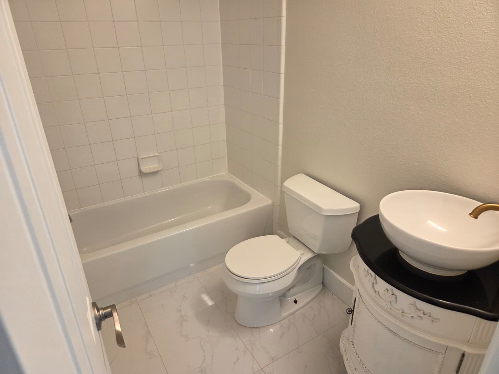 7019 Brody Lane Houston, TX 77083 - Photo 21 of 26 a white toilet sitting next to a bath tub and a shower