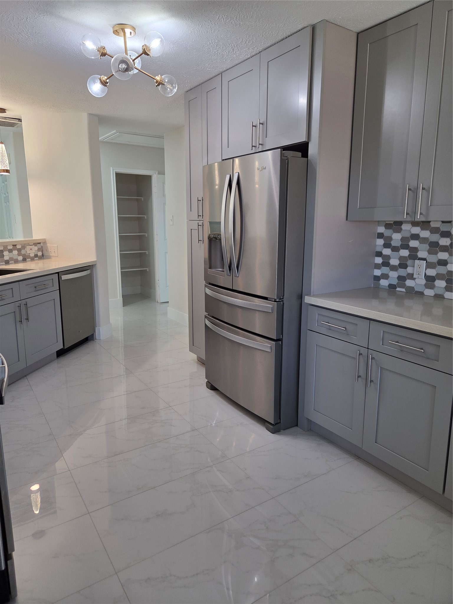 7019 Brody Lane Houston, TX 77083 - Photo 5 of 26 a kitchen with a refrigerator sink and cabinets