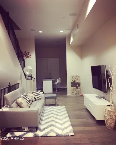 a living room with furniture rug and wooden floor