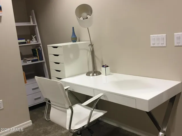 a room with table chairs and white appliances