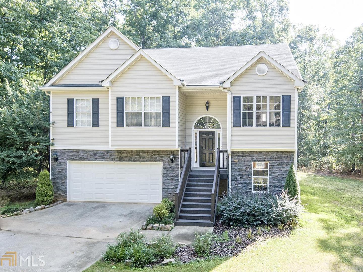 552 Leguin Mill Road Locust Grove, GA 30248 - Photo 1 of 1 a front view of a house with a yard and garage