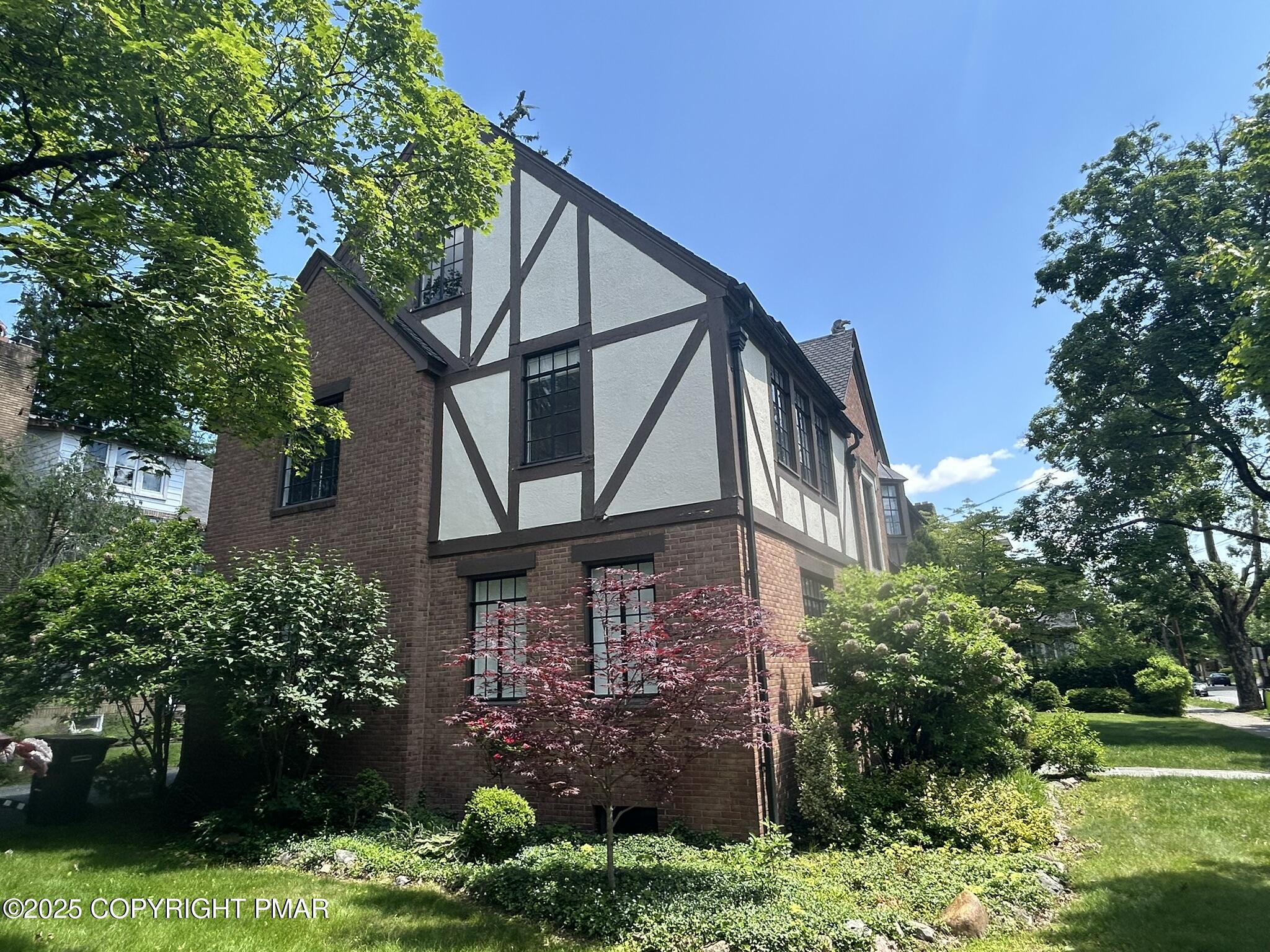 540 Sarah Street, Unit 102 Stroudsburg, PA 18360 - Photo 2 of 12 a front view of a house with garden