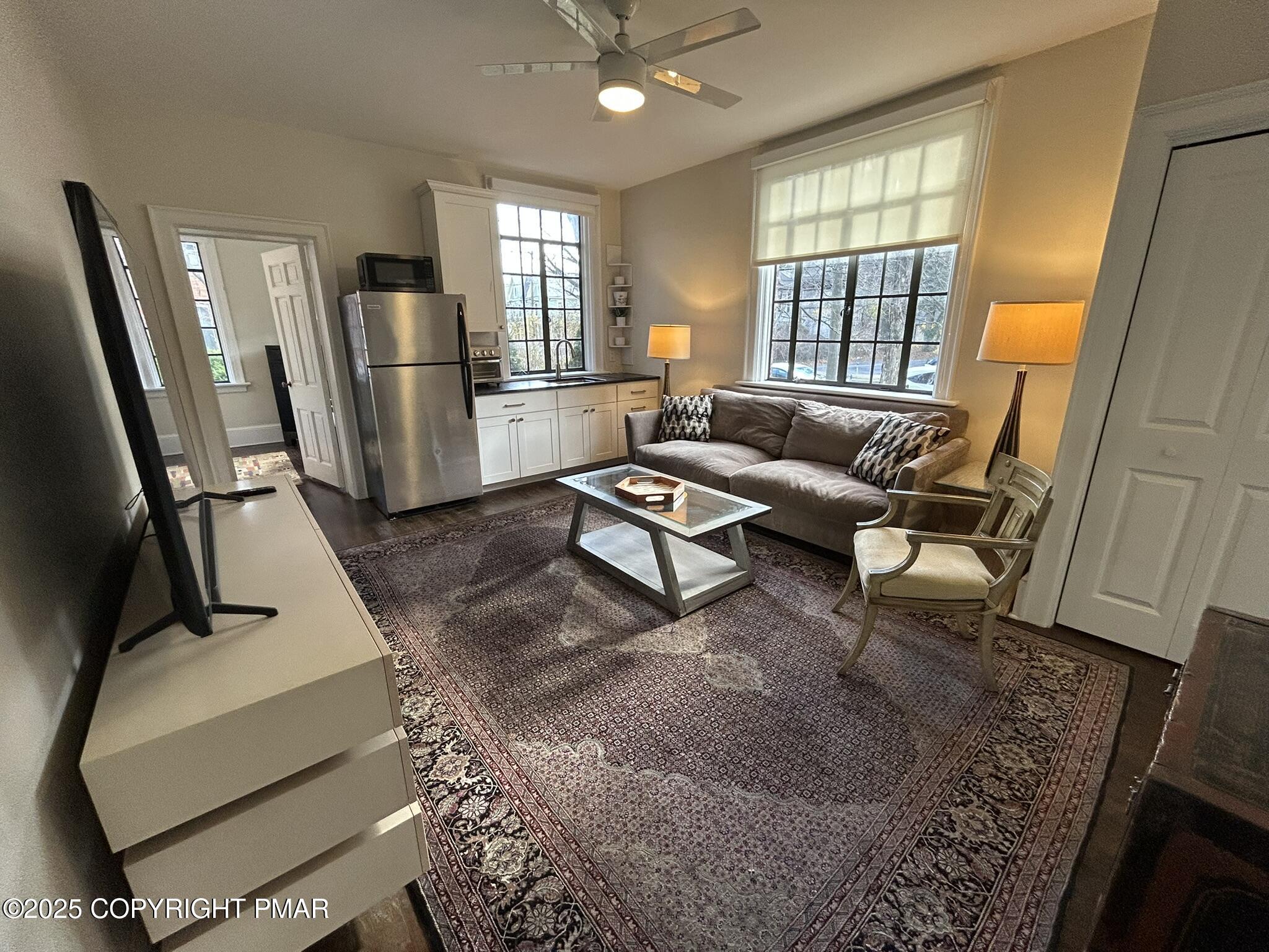 540 Sarah Street, Unit 102 Stroudsburg, PA 18360 - Photo 4 of 12 a living room with furniture and a window