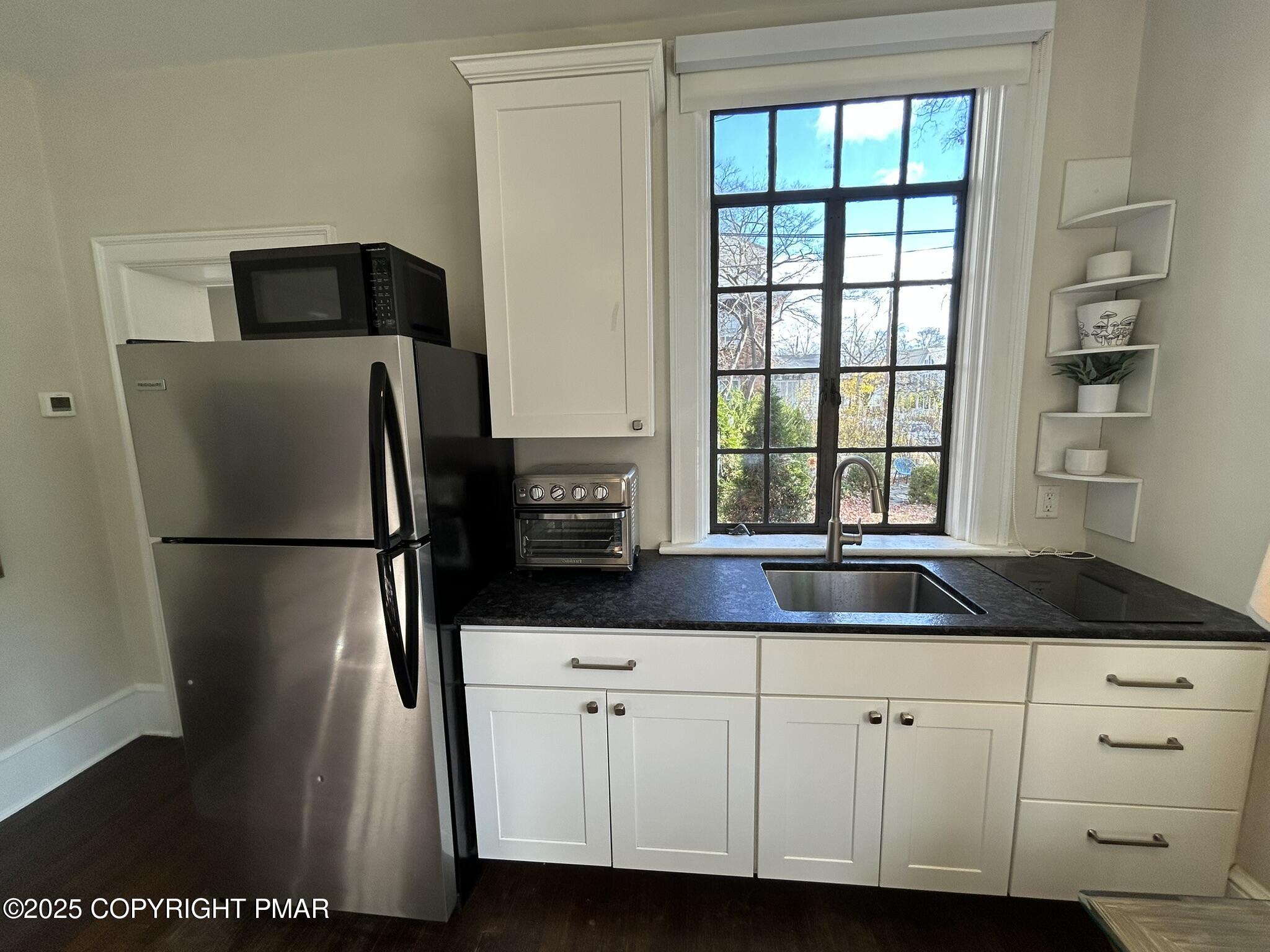 540 Sarah Street, Unit 102 Stroudsburg, PA 18360 - Photo 7 of 12 a kitchen with appliances a counter space and a window