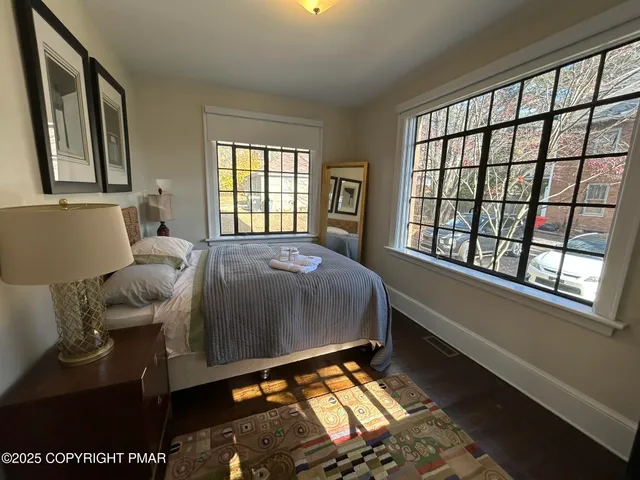 a bed sitting in a bedroom next to a window