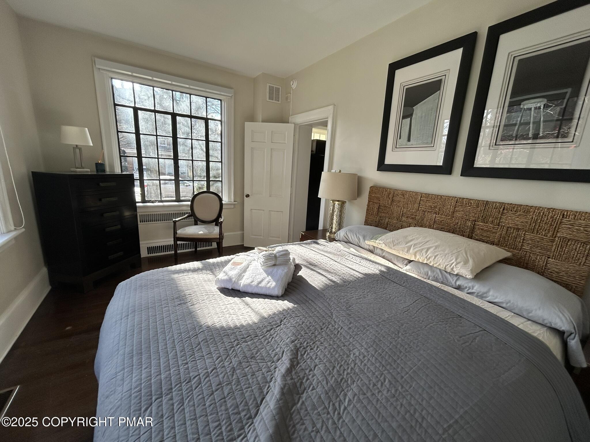 540 Sarah Street, Unit 102 Stroudsburg, PA 18360 - Photo 9 of 12 a bedroom with a bed mirror and window