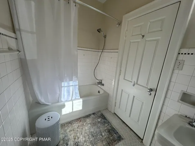 a bathroom with a tub and a shower