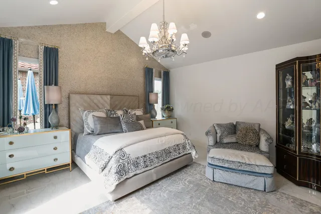 a bedroom with a bed and a chandelier