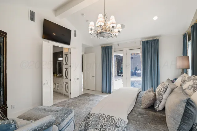 a bedroom with a bed and a television