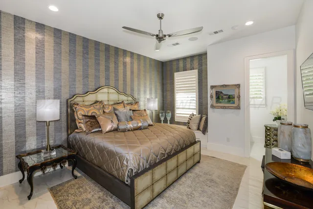 a bedroom with a bed and a lamp on table