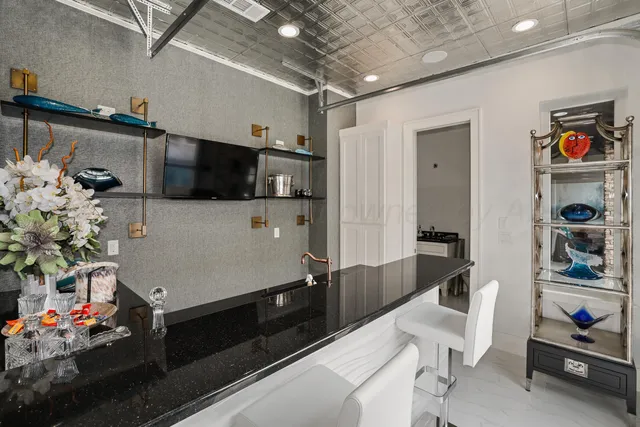 a view of a patio with table and chairs with barbeque grill and couches