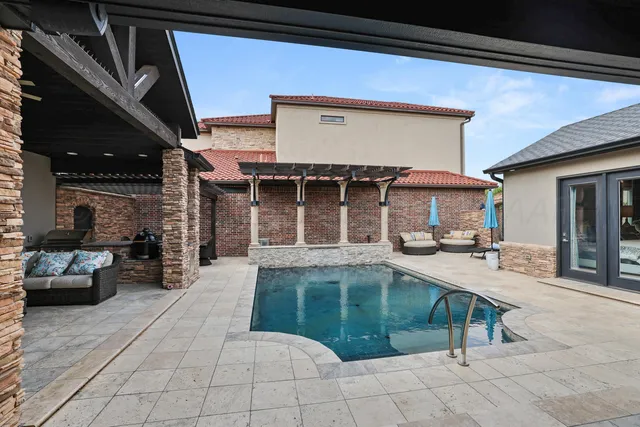 a view of a dinning table and chairs in patio of the house