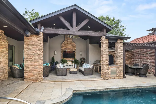a outdoor living space with furniture potted plant and a large window