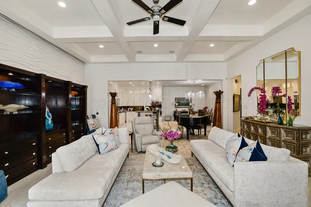 a living room with furniture and kitchen view