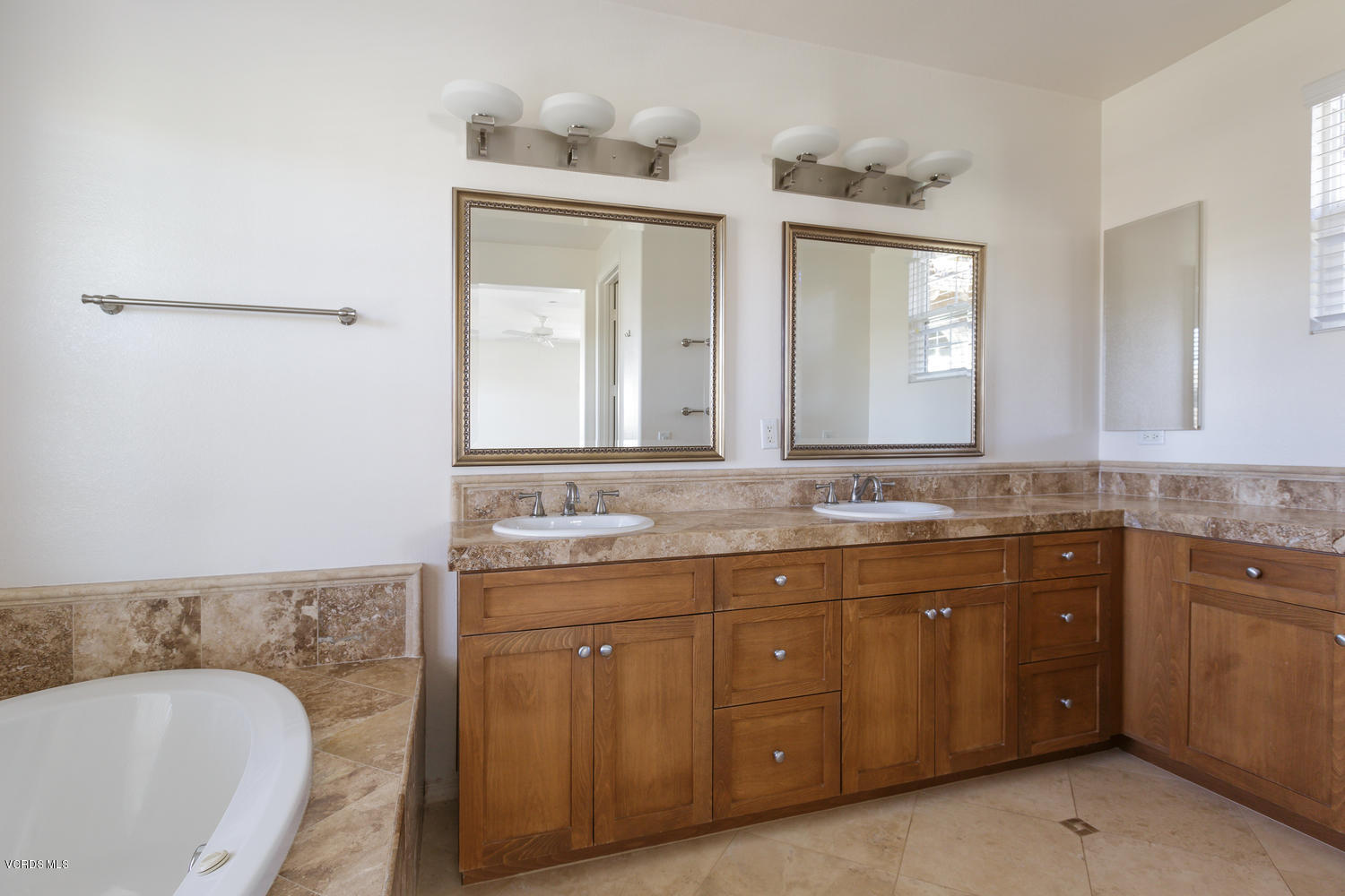 1455 Donegal Way Oxnard, CA 93035 - Photo 19 of 32 a spacious bathroom with a granite countertop sink and a mirror