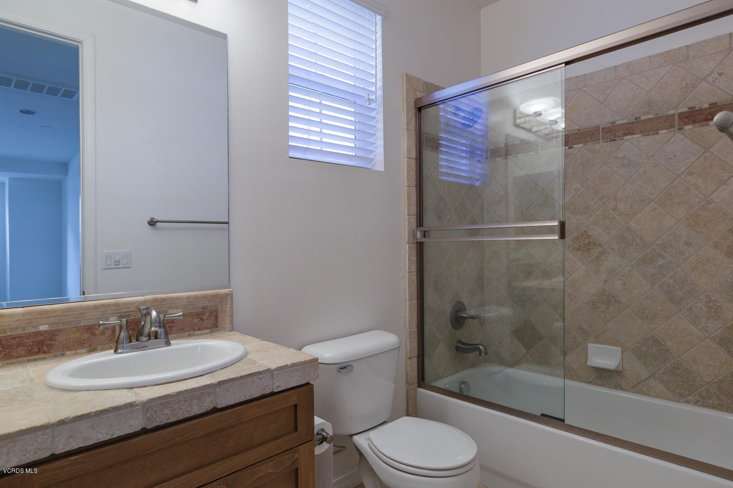 1455 Donegal Way Oxnard, CA 93035 - Photo 22 of 32 a bathroom with a sink toilet a mirror and shower