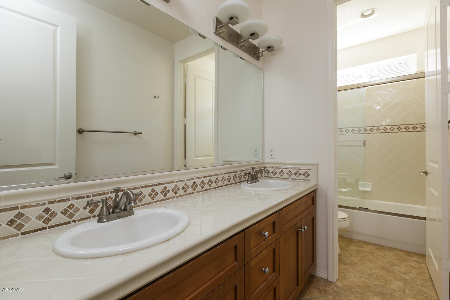 1455 Donegal Way Oxnard, CA 93035 - Photo 24 of 32 a bathroom with a sink and a mirror