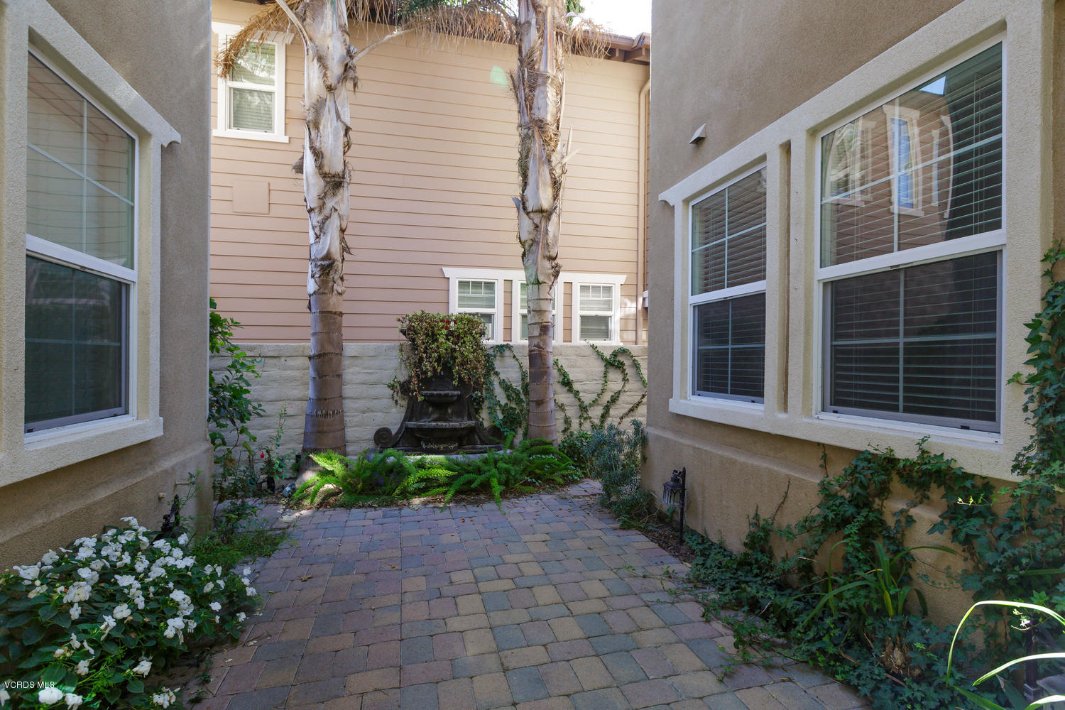 1455 Donegal Way Oxnard, CA 93035 - Photo 27 of 32 a view of a pathway with potted plants in front of house