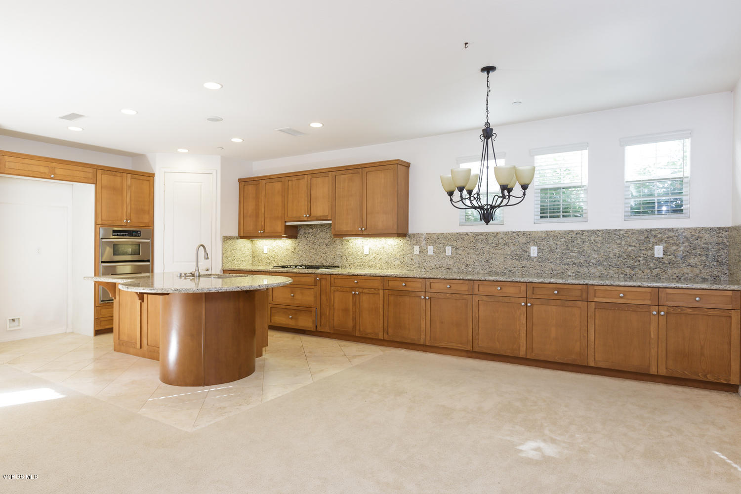 1455 Donegal Way Oxnard, CA 93035 - Photo 5 of 32 a kitchen with granite countertop white cabinets a stove a sink and dishwasher