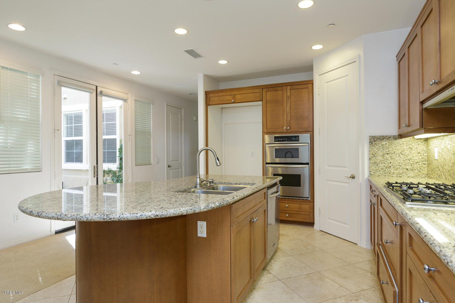 1455 Donegal Way Oxnard, CA 93035 - Photo 9 of 32 a kitchen with kitchen island granite countertop a stove and a sink