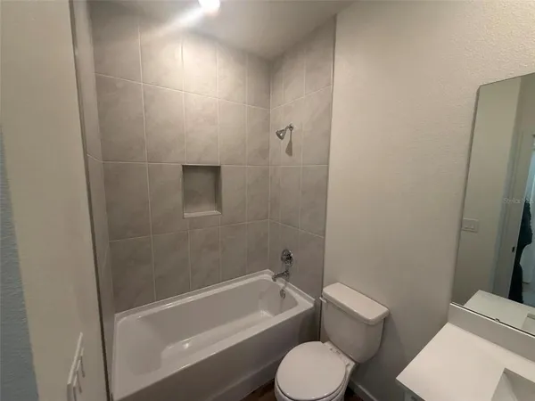 a bathroom with a toilet a sink and bathtub