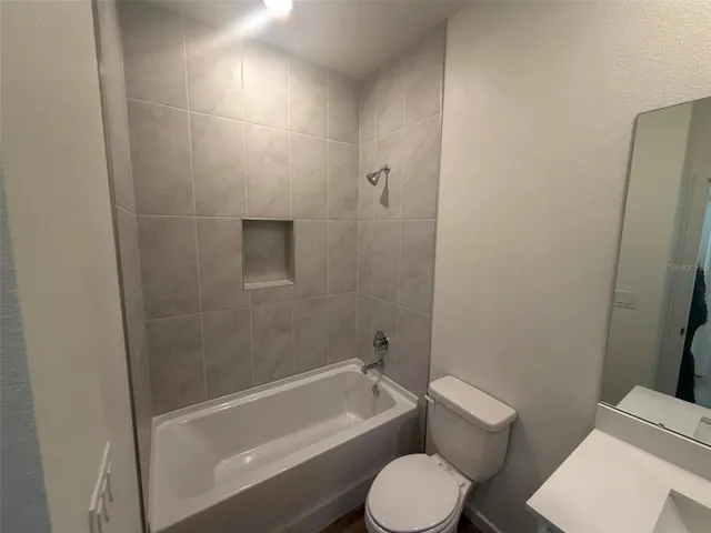 a bathroom with a toilet a sink and bathtub