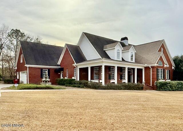 a front view of house with yard and trees around