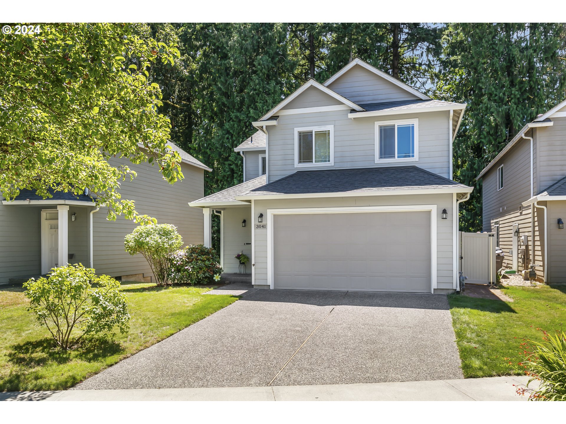 3041 South Cedar Ridge Drive Ridgefield, WA 98642 - Photo 1 of 26 a front view of a house with a yard and garage