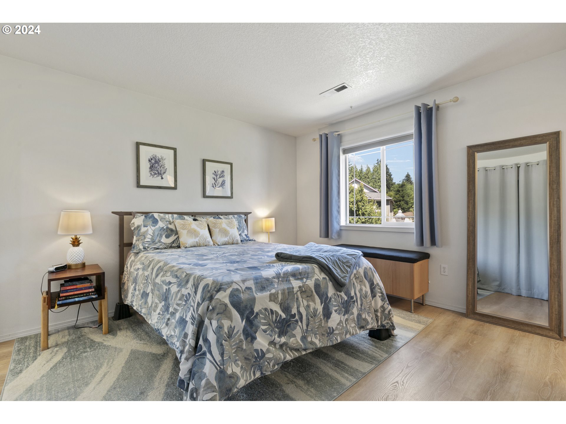 3041 South Cedar Ridge Drive Ridgefield, WA 98642 - Photo 14 of 26 a bedroom with a bed and a painting on the wall