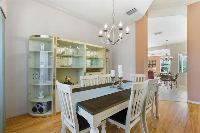 a view of a dining room with furniture and chandelier