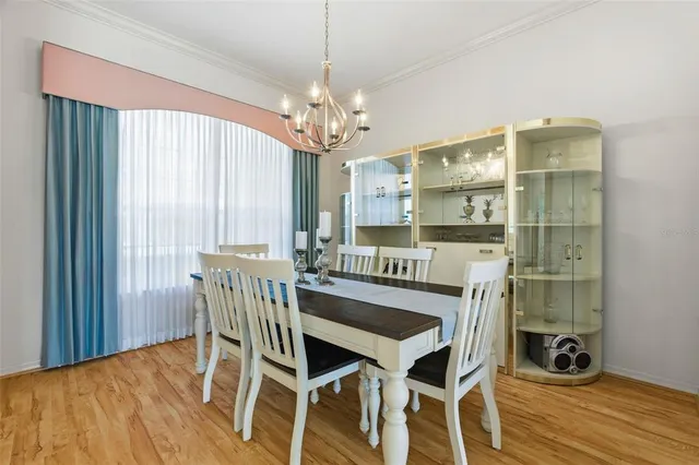 a view of a dining room with furniture wooden floor and chandelier