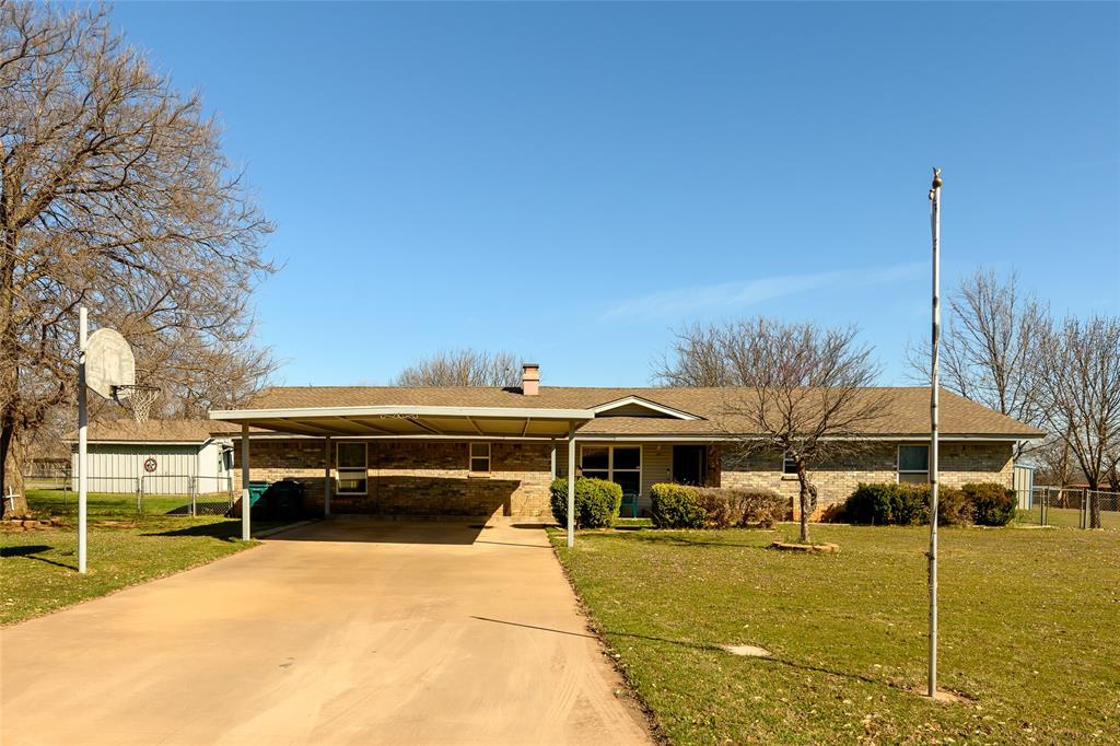 125 Royal Road Wichita Falls, TX 76308 - Photo 1 of 1 Ranch-style home featuring driveway, a front yard, an attached carport, a chimney, and fence