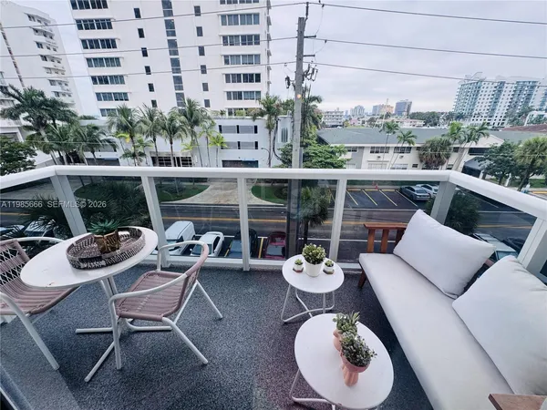 a view of a patio with a table and chairs
