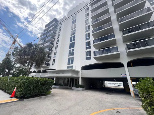 a living room with furniture gym equipment and kitchen view