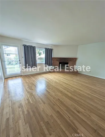 an empty room with closet and windows