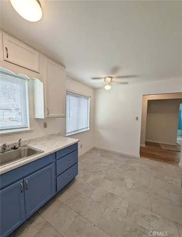 a view of an empty room with window and cabinet