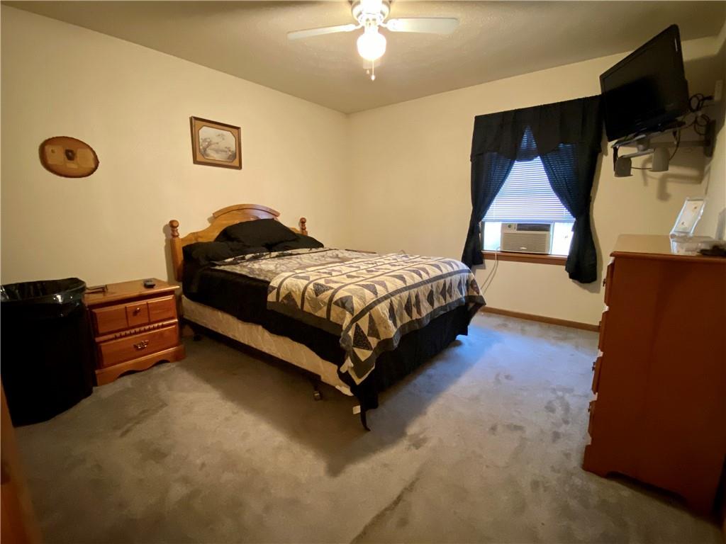 1564 Hells Kitchen Road Polk, PA 16342 - Photo 14 of 25 a bedroom with a bed and a chandelier